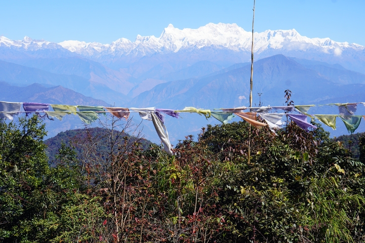 Colorful prayer flags with mountains in the background