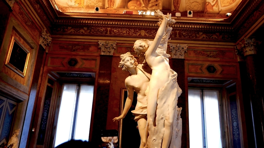 Statue of Apollo and Daphne inside a gallery.