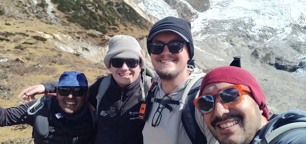 Group of friends posing in a mountainous landscape