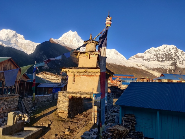 Traditional architecture with snowy peaks in the distance