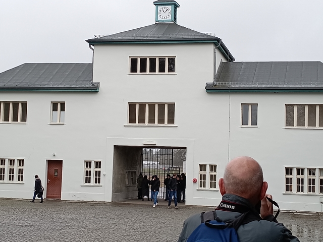 Entrance to a historical building with visitors approaching.