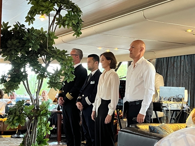 Four crew members standing inside a ship.