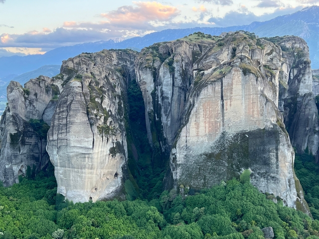 Towering rock formations with vegetation.