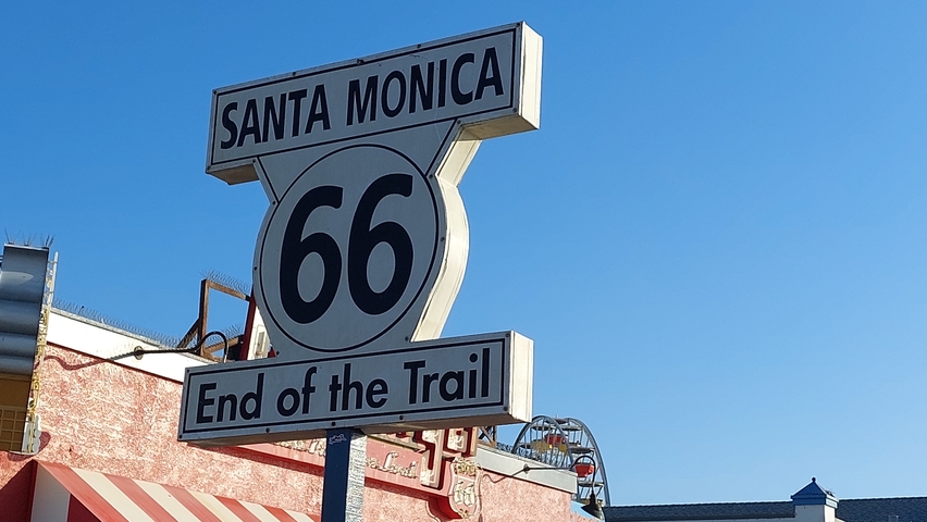 Santa Monica Route 66 End of Trail sign with blue sky background.