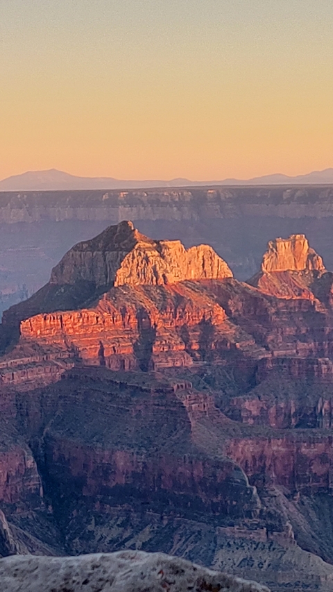 Grand Canyon view during sunset with orange rock formations.