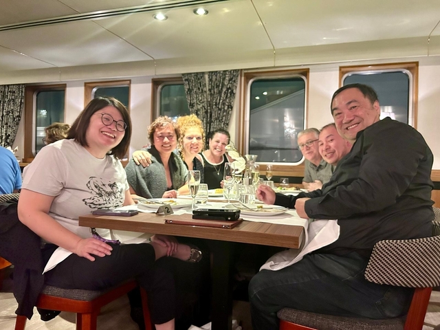 Group of people having dinner inside a dining area.