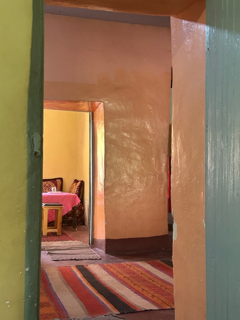 Interior of a room with colorful walls and a round table.
