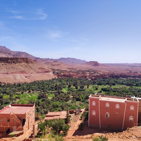 Scenic view of a desert village with mountains in the background.