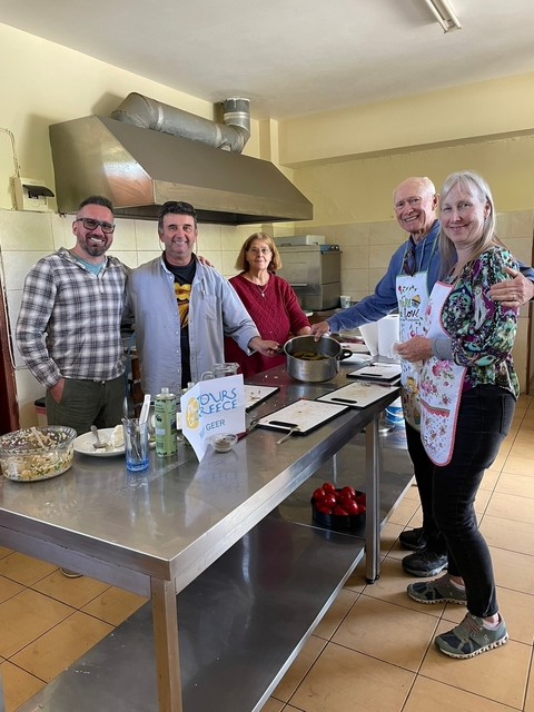 Group cooking class in a kitchen setting.