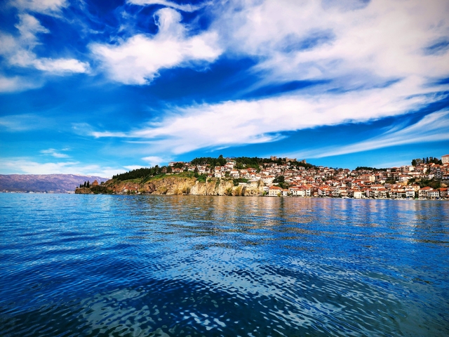 Coastal cityscape with blue sky and sea.