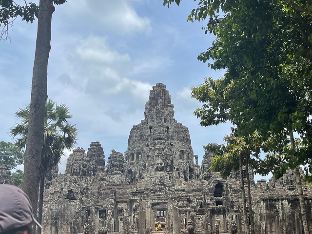 Ancient temple ruins with trees in the background.
