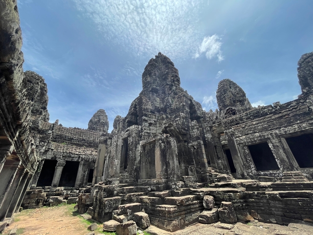 Large stone temple with cloudy sky.