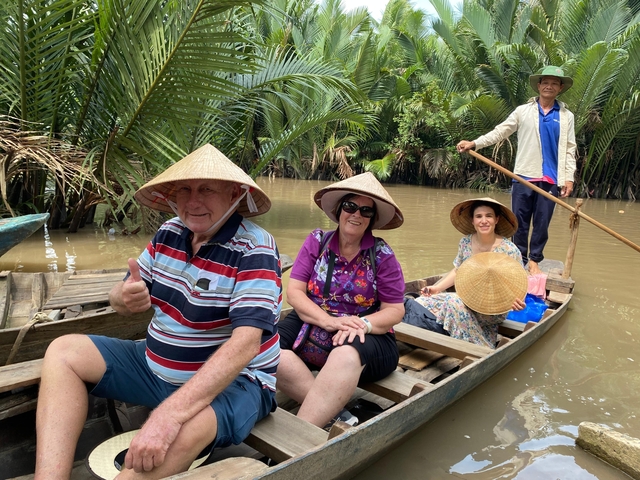 People in traditional boats in a river.