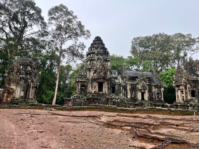 Ruins of an ancient stone complex in a lush setting.