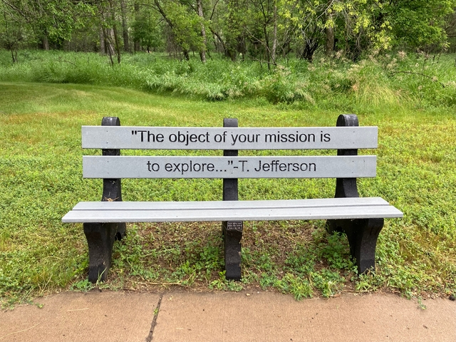 Bench in a park with a quote attributed to T. Jefferson.