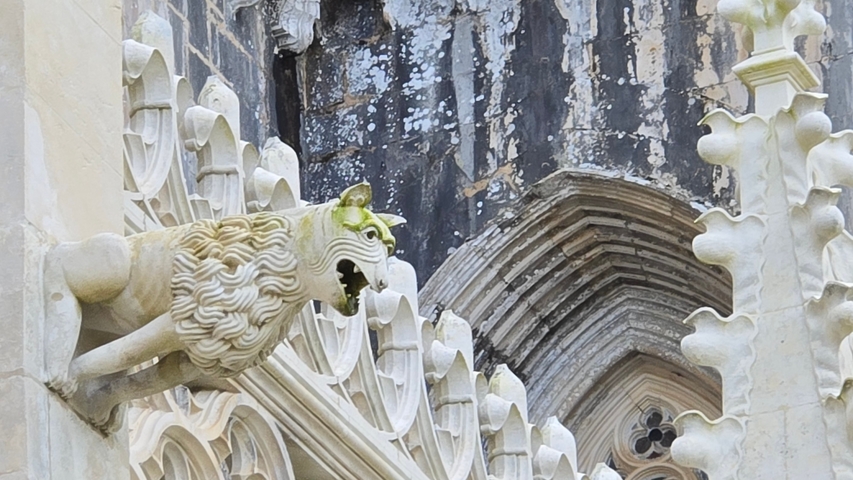 Architectural detail of a gargoyle on a historic building.