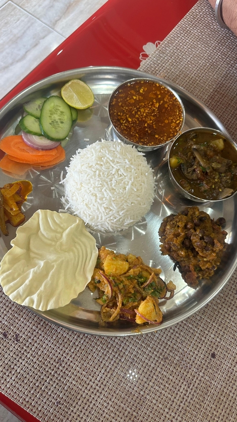Plate of rice with various side dishes.
