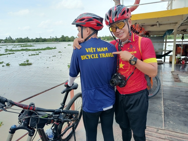 Cyclists posing with a Vietnam Bicycle Travel shirt.