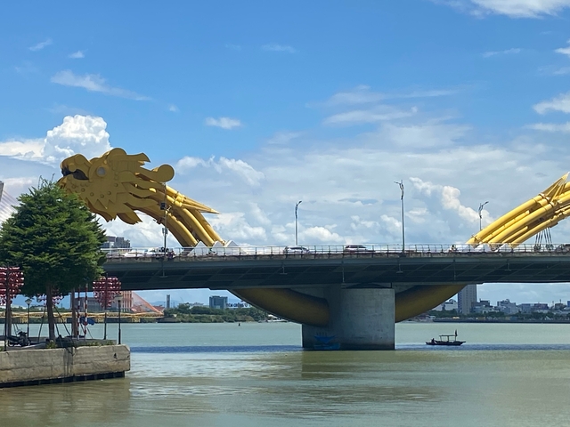 A golden dragon bridge spanning over a river.