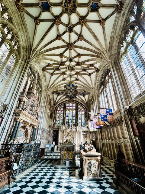 Intricately designed cathedral ceiling with stained glass windows.