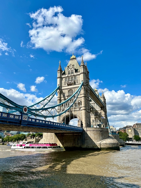 Iconic bridge with blue sky and clouds.