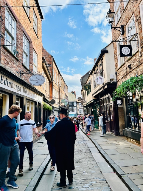 Bustling street with historic buildings and people.
