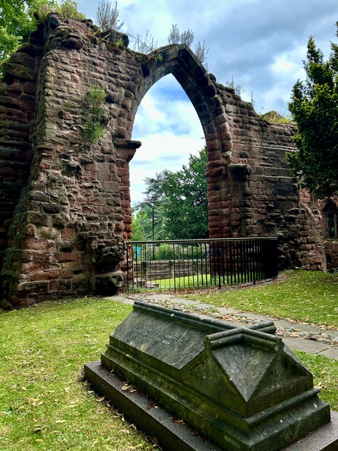 Ruins of an old stone structure in a park.