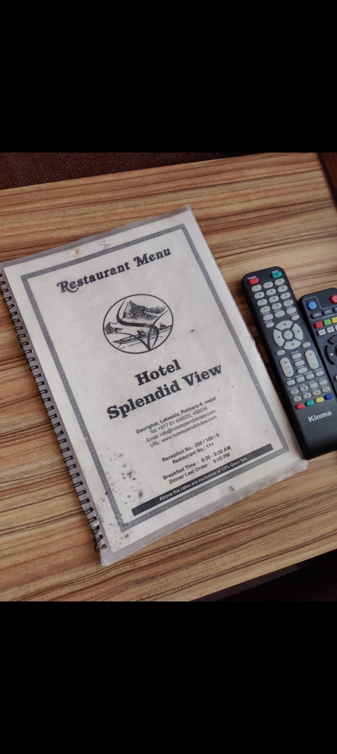 Hotel informational paper with remote controls.