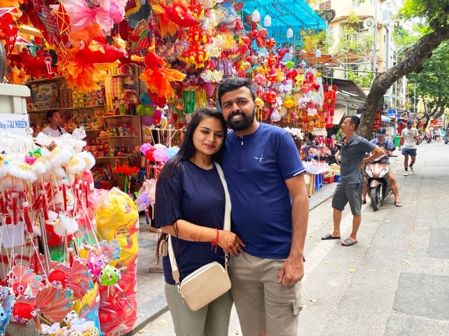 Couple posing in a colorful market street.