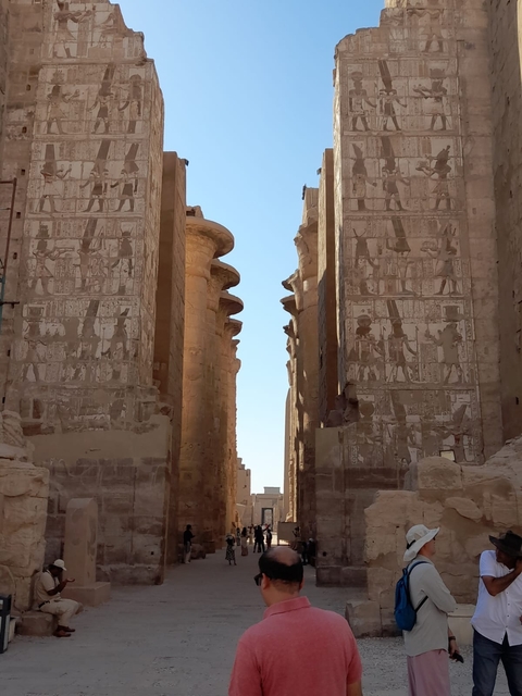 Close-up of tall ancient Egyptian stone carvings with hieroglyphics.