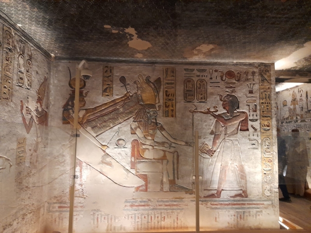 Interior of an ancient Egyptian temple with colorful hieroglyphics.