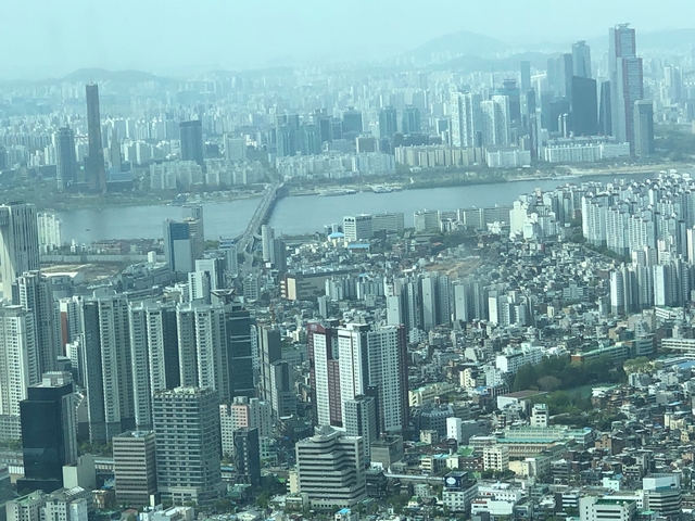 Aerial view of a river running through a city with skyscrapers.