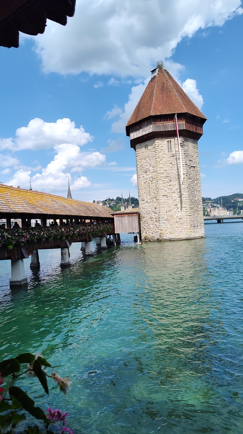 Chapel Bridge and tower over a river in Lucerne.