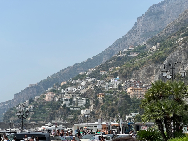 Buildings perched on a steep coastal cliff.