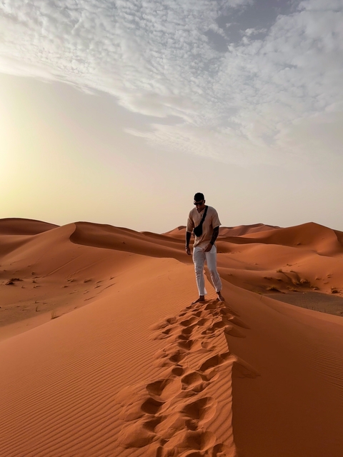 Person walking on sand dunes