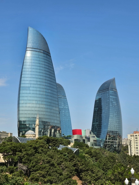 Three modern towers with reflective glass surfaces.