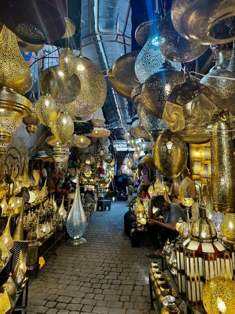 An alley full of ornamental lights in a Moroccan market.