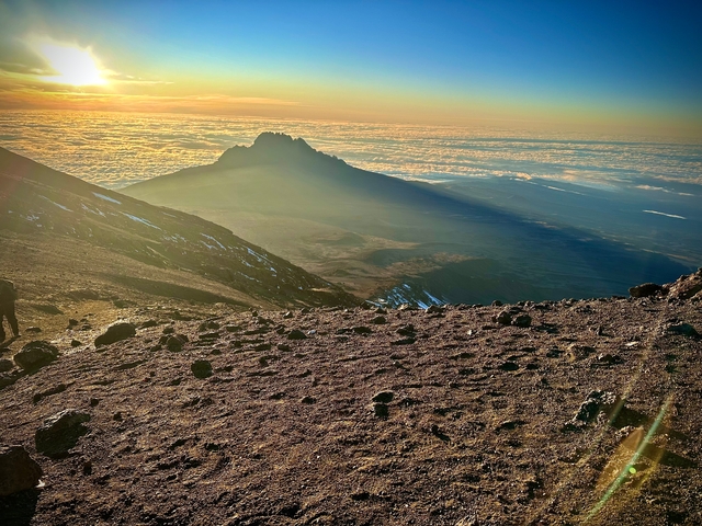 Mountain view with a sunset over clouds.