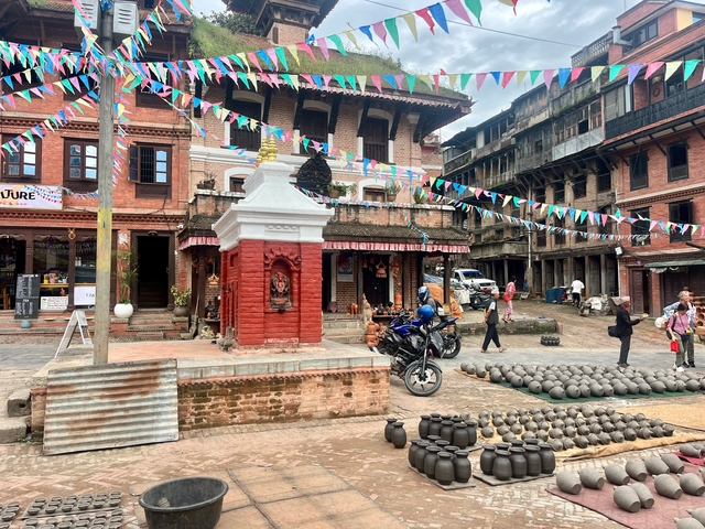 Colorful square with traditional buildings and pottery.