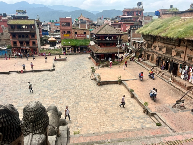 Aerial view of a historic square with people.