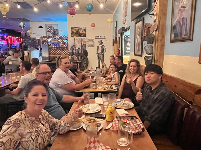 People enjoying a meal inside a rustic restaurant.