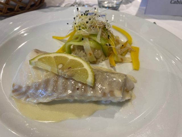 Decorative food dish with fish, lemon, and garnish on a plate.