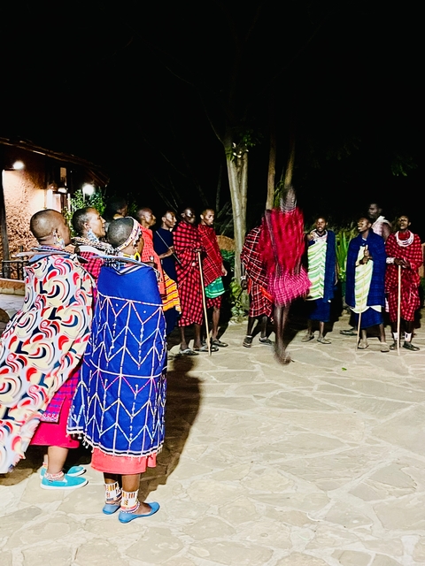 Group of Maasai people in traditional attire during a dance.