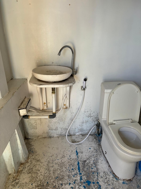 Rustic bathroom setup with sink and toilet.