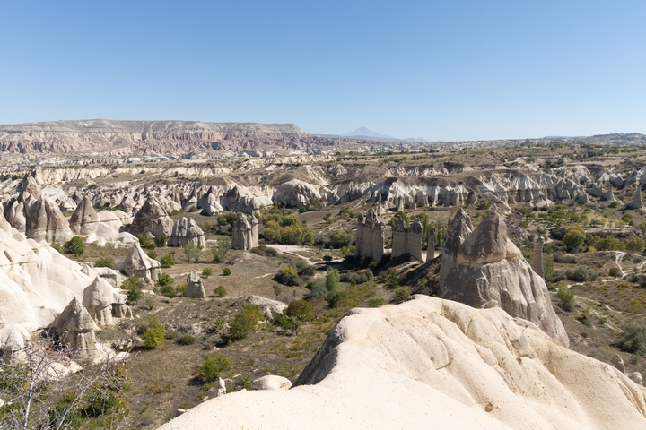 The unique rock formations in Cappadocia under clear skies.
