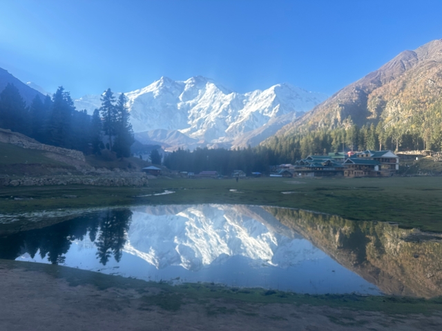 Scenic view of snow-capped mountains reflecting in a calm lake.