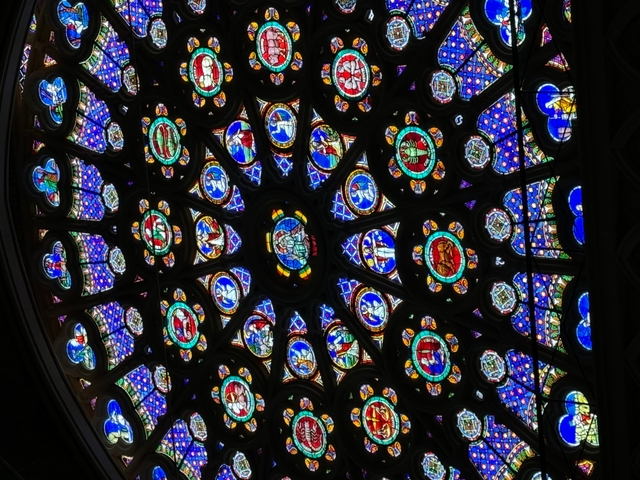 A detailed view of a circular stained glass window.