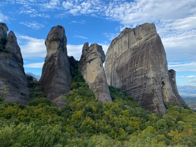 Tall rock formations in a lush valley.