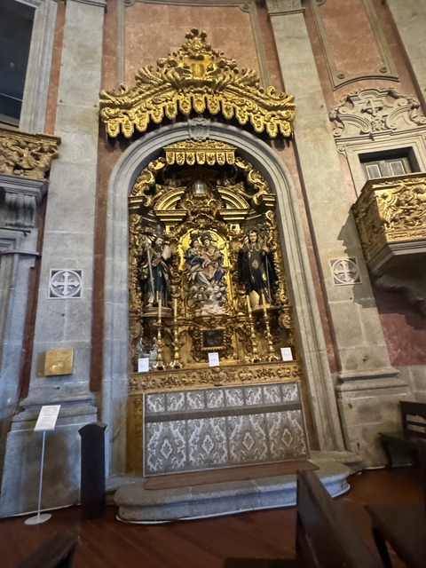 Opulent altar inside a European church with ornate decor.