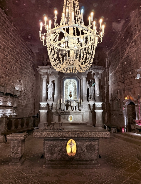 Interior of a chapel with statues and chandelier